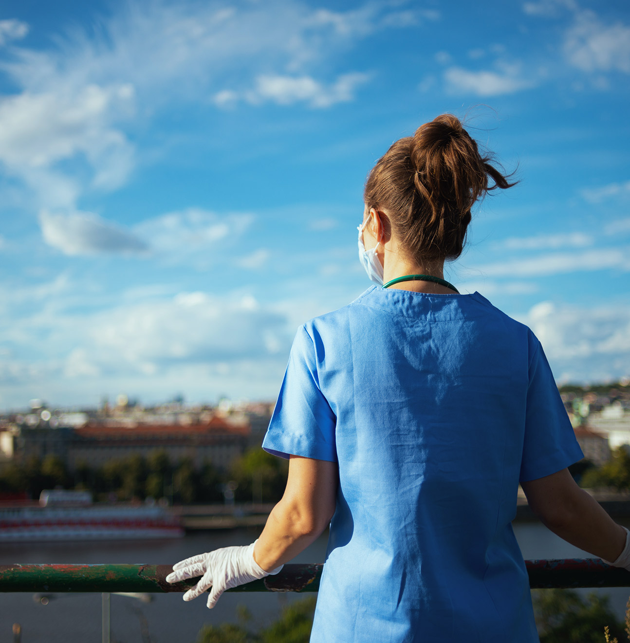 Doctor overlooking the city from a roof view